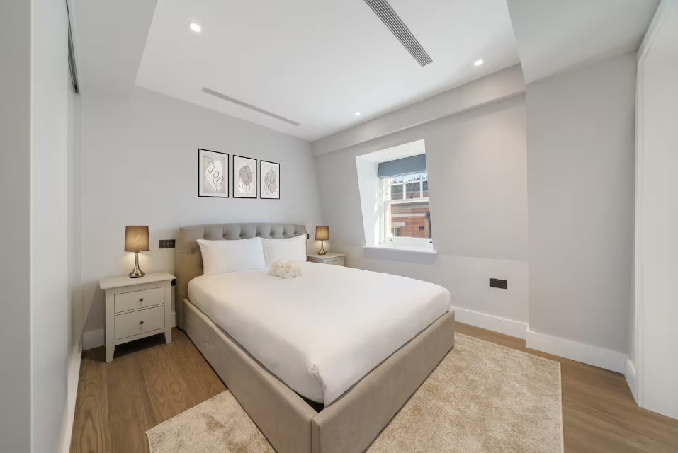 Elegant bedroom with bedside lamps and framed artwork